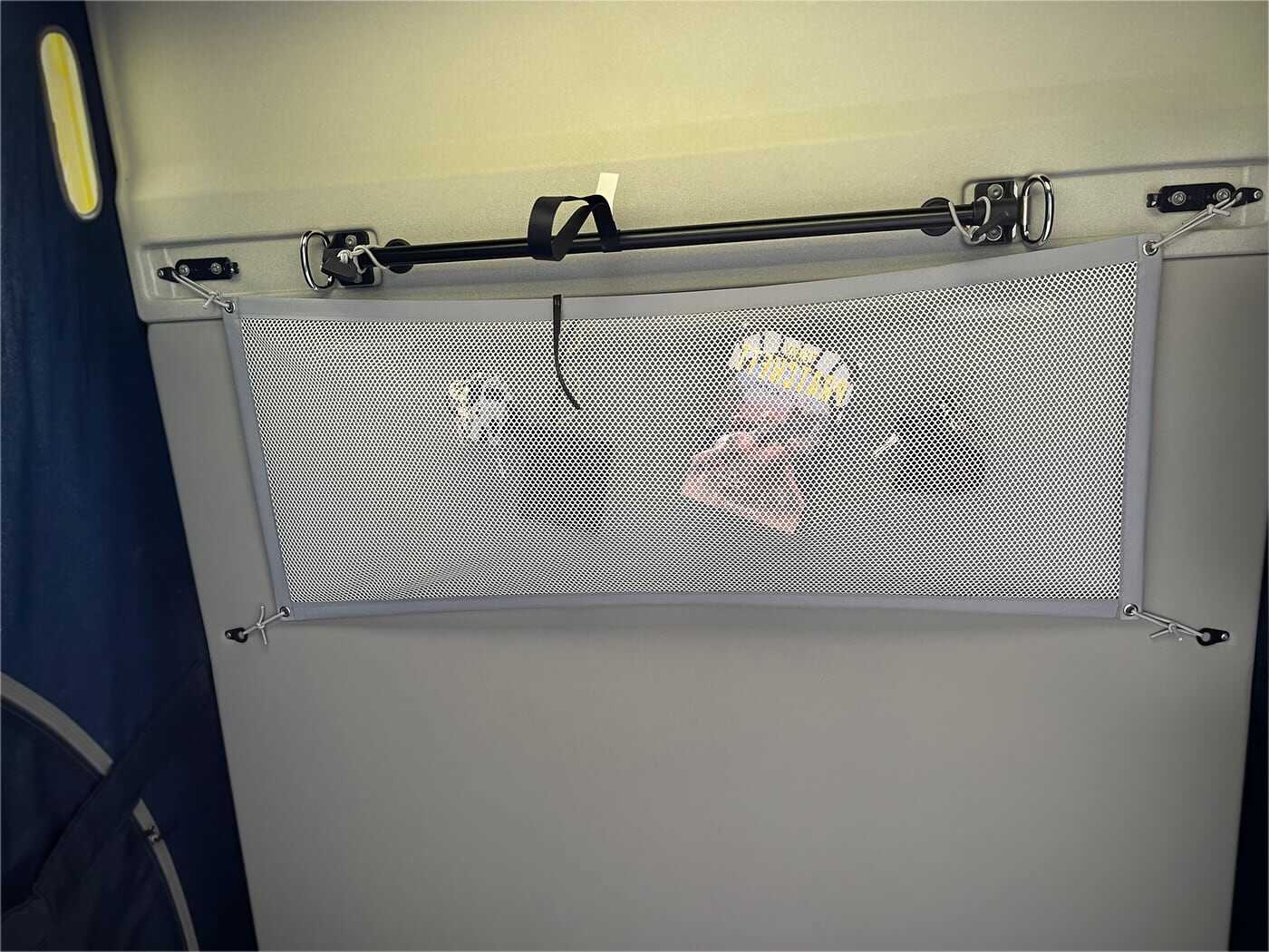 Storage net with book, wallet and key in the VW California pop-up roof