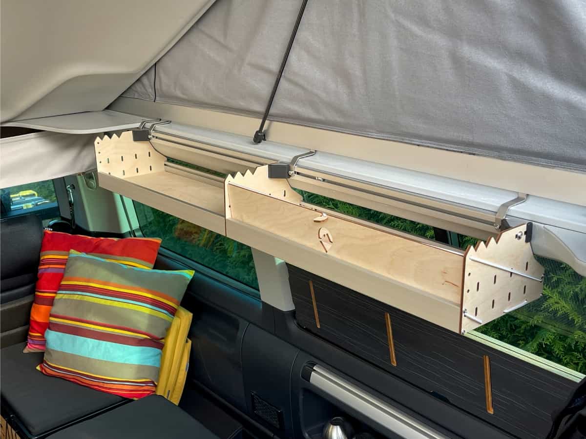 Two wooden shelves Two wooden shelves in the extended roof of the campervan, including the extension with cushions
